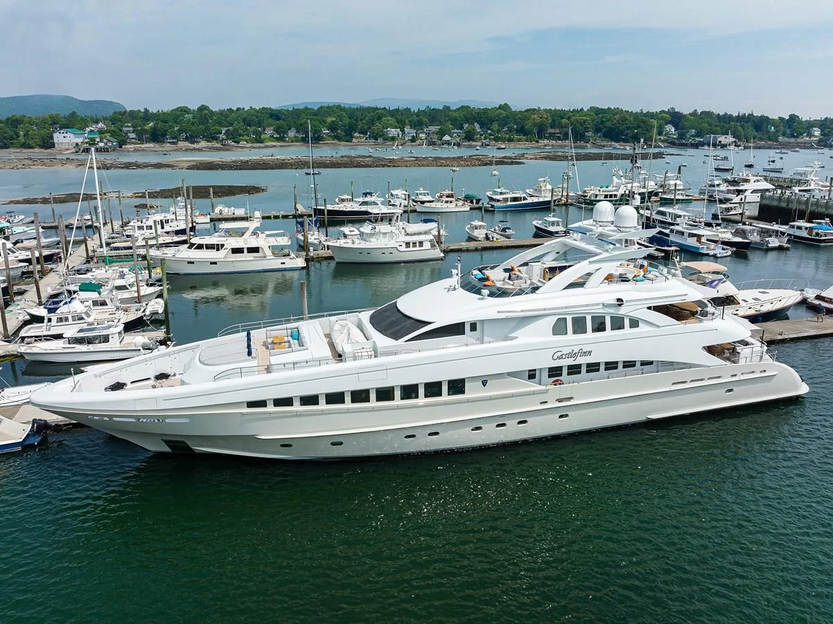 a large white yacht in a harbor aboard SHARKFINN Yacht for Sale