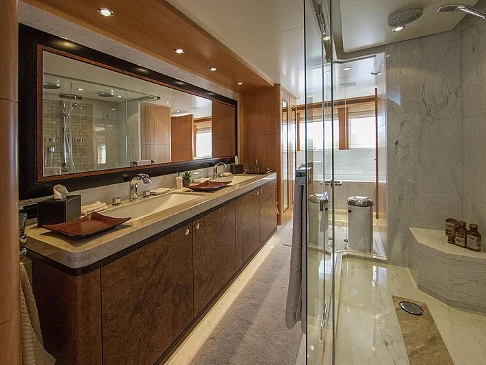 a bathroom with a large mirror aboard SHARKFINN Yacht for Sale