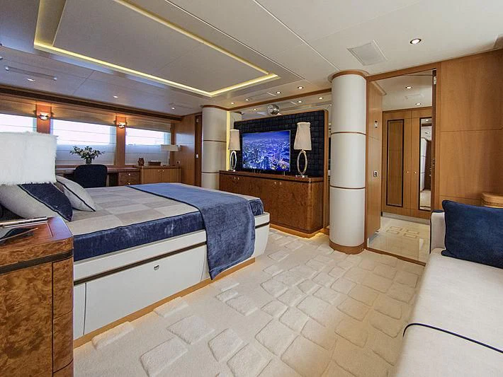 a hotel room with a bed and a tv aboard SHARKFINN Yacht for Sale