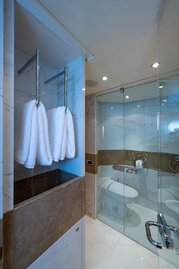 a bathroom with a glass shower aboard SHARKFINN Yacht for Sale