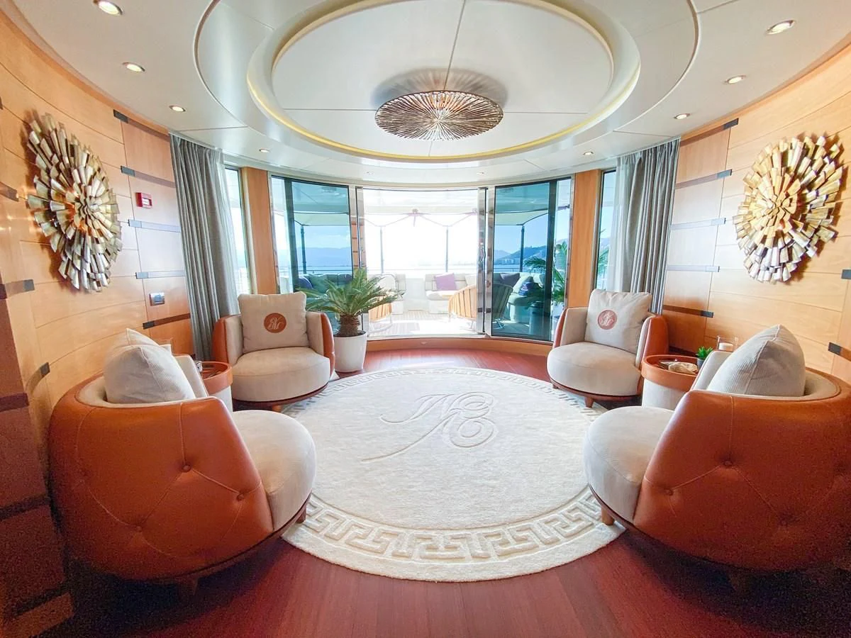a large living room with a large chandelier aboard SHARKFINN Yacht for Sale
