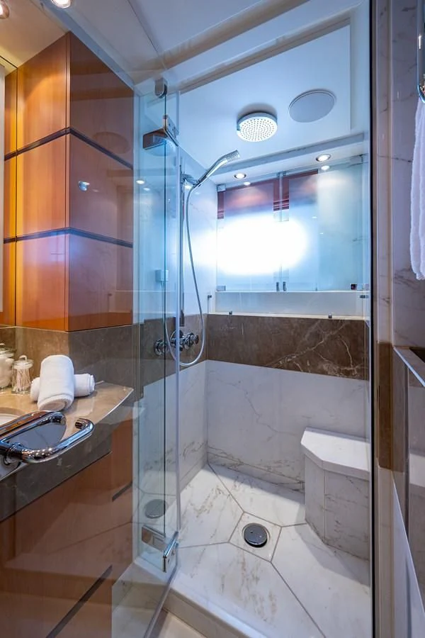 a bathroom with a glass shower aboard SHARKFINN Yacht for Sale