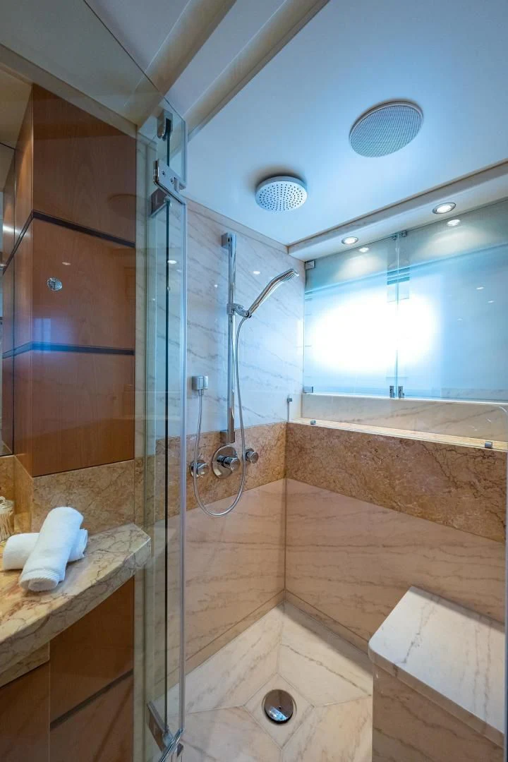 a bathroom with a shower unit and a sink aboard SHARKFINN Yacht for Sale