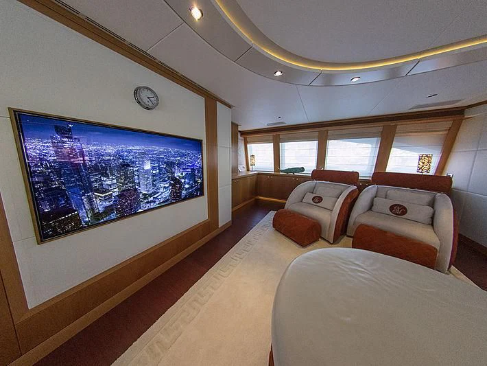 a living room with a large screen aboard SHARKFINN Yacht for Sale