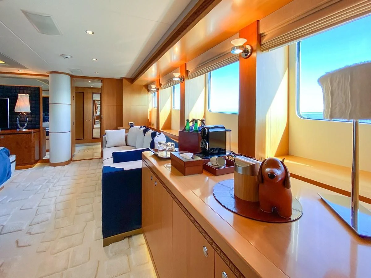a large room with a table and a mirror aboard SHARKFINN Yacht for Sale