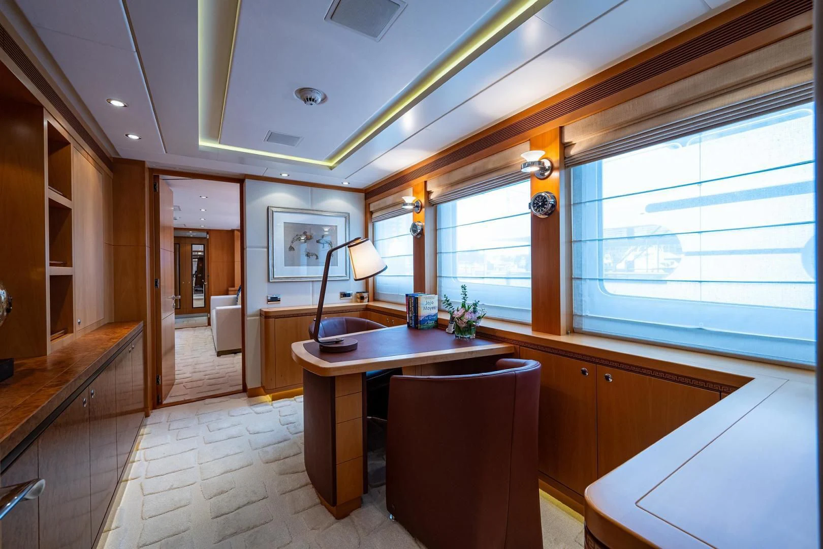 a kitchen with a bar and a table aboard SHARKFINN Yacht for Sale