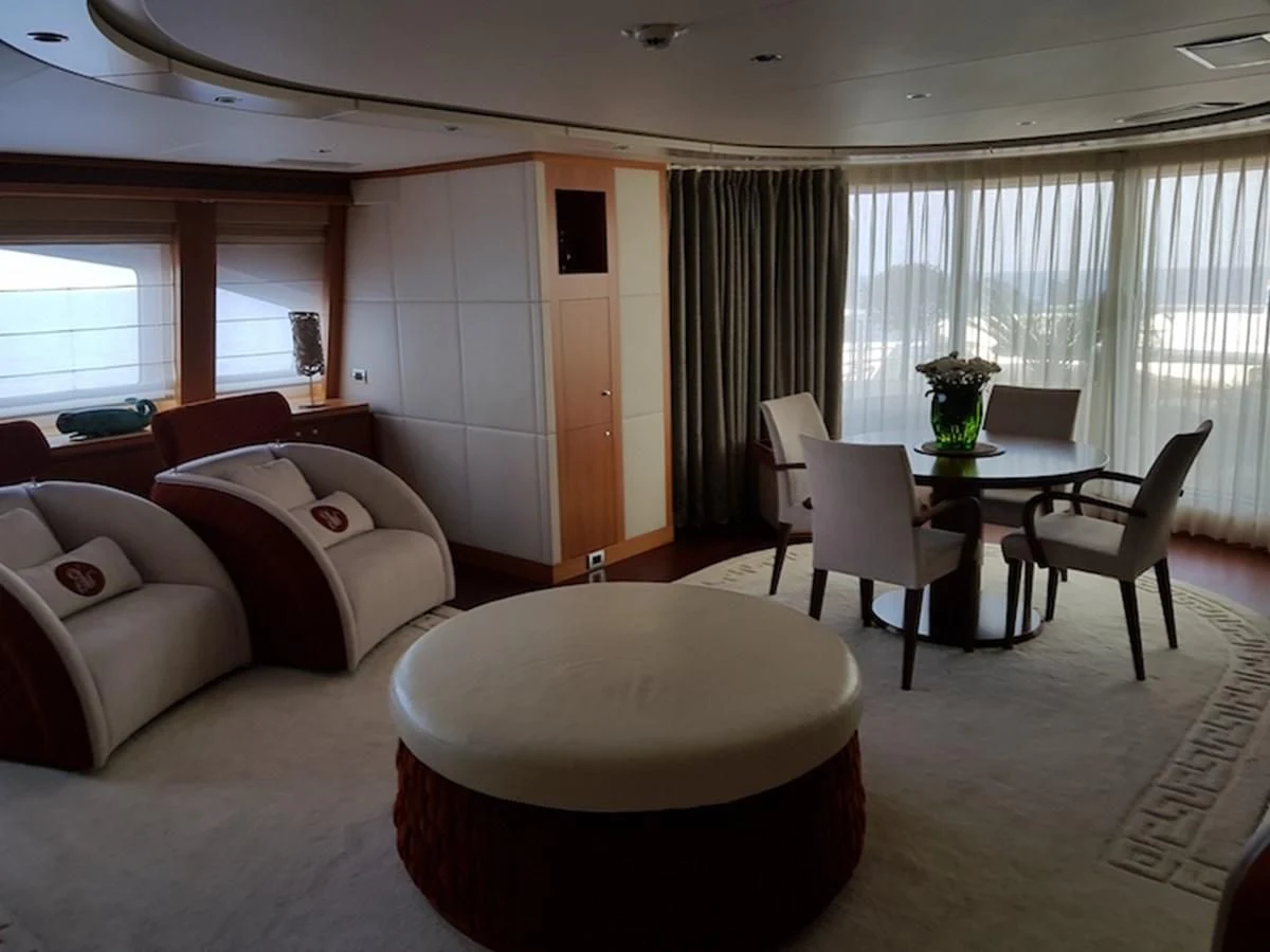 a living room with a table and couches aboard SHARKFINN Yacht for Sale