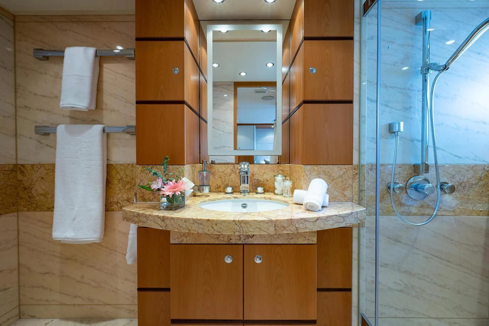 a bathroom with a sink and shower aboard SHARKFINN Yacht for Sale
