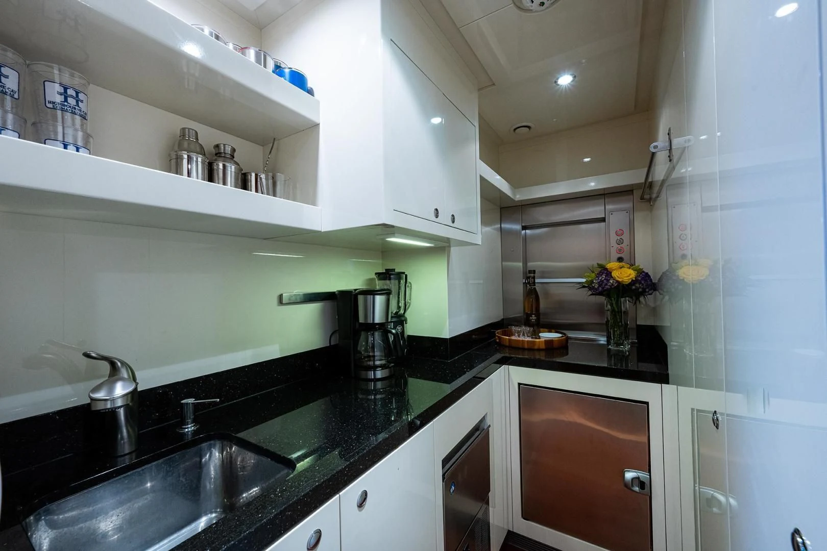 a kitchen with a sink and cabinets aboard SHARKFINN Yacht for Sale