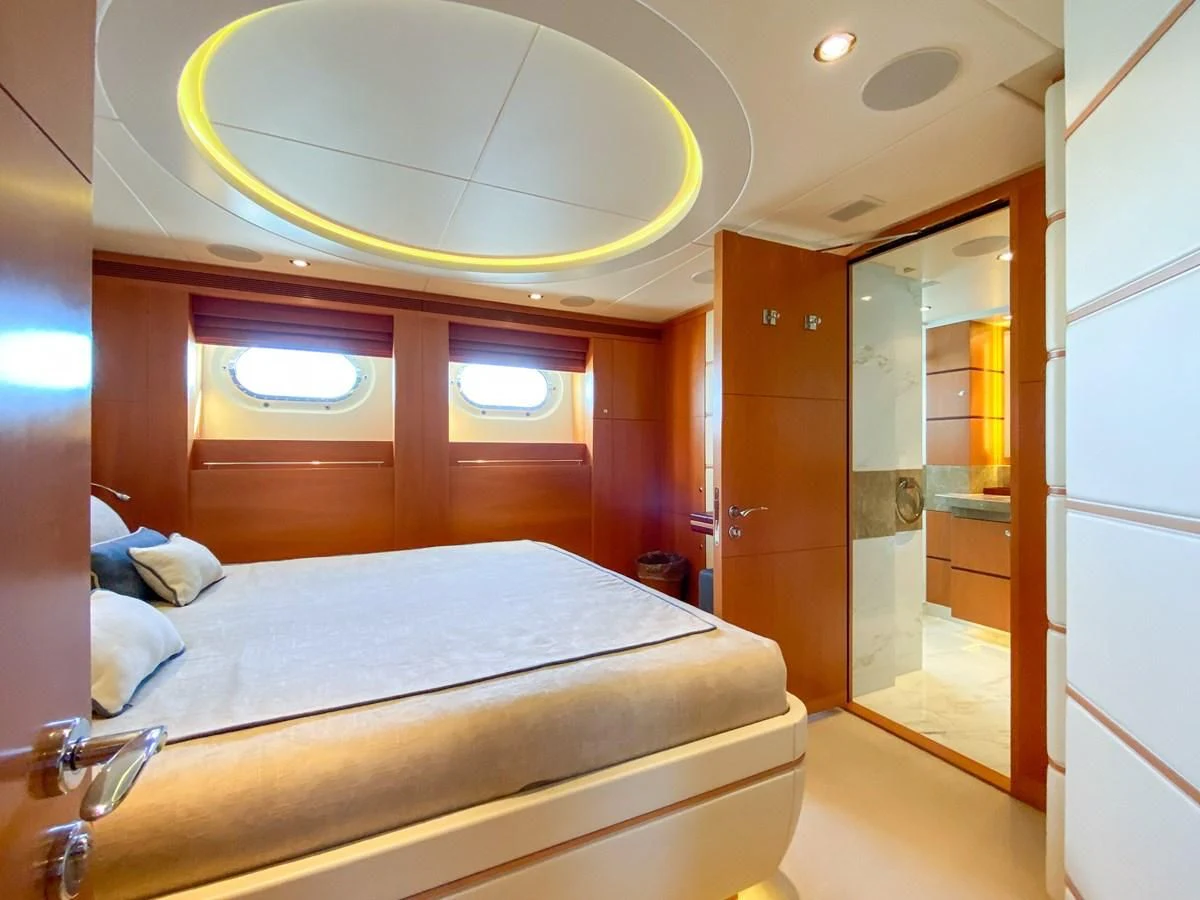 a room with a bed and a mirror aboard SHARKFINN Yacht for Sale