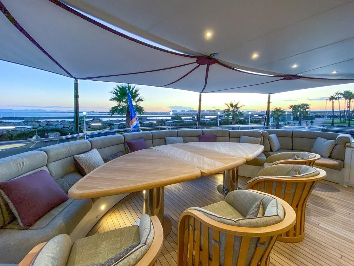 a table and chairs on a deck aboard SHARKFINN Yacht for Sale