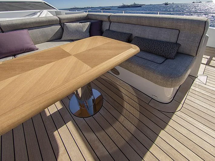 a wood table on a deck aboard SHARKFINN Yacht for Sale