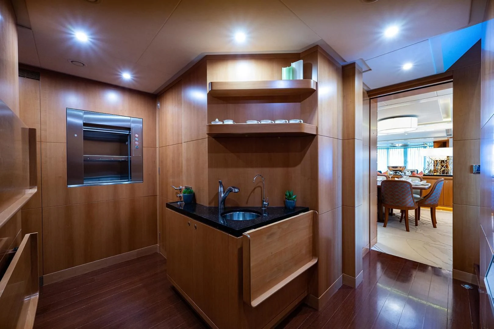 a kitchen with a sink and a wood cabinet aboard SHARKFINN Yacht for Sale