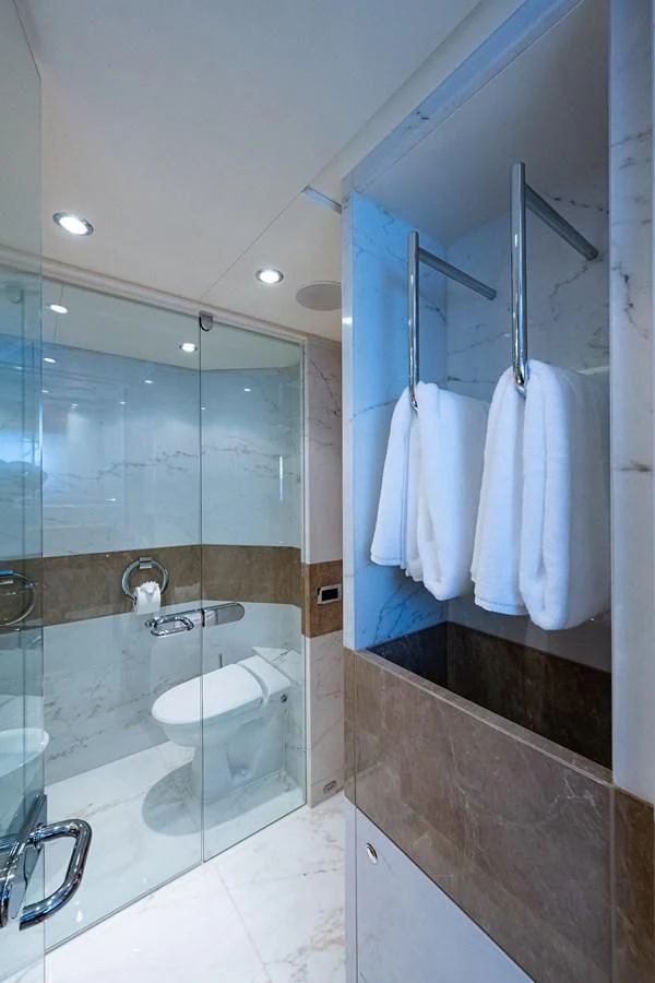 a bathroom with a glass shower aboard SHARKFINN Yacht for Sale