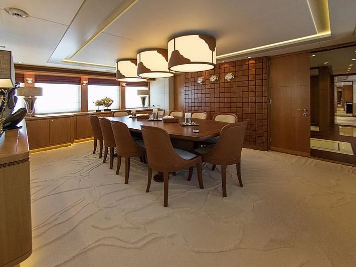 a large room with a table and chairs aboard SHARKFINN Yacht for Sale