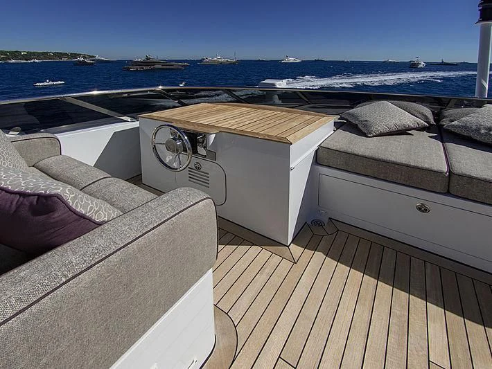 a deck with a boat and a large body of water in the background aboard SHARKFINN Yacht for Sale