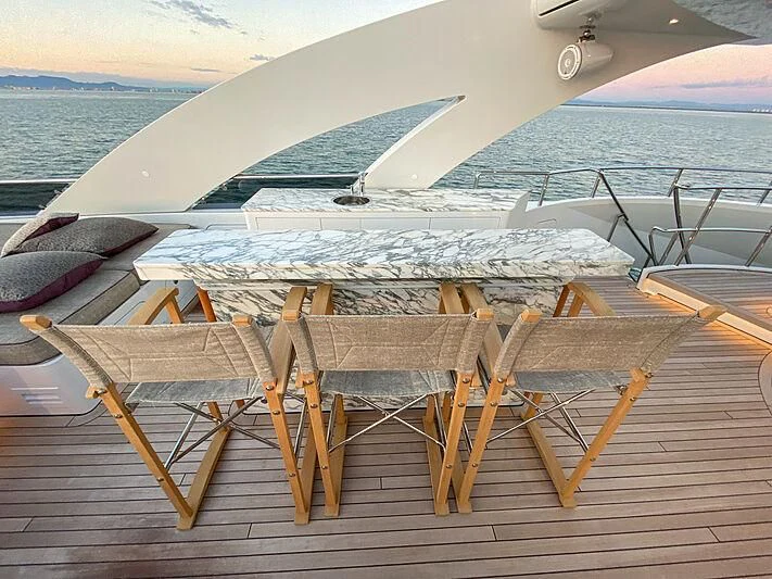 a deck with chairs on it aboard SHARKFINN Yacht for Sale
