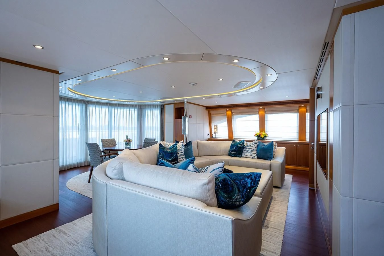 a large living room with a large chandelier aboard SHARKFINN Yacht for Sale