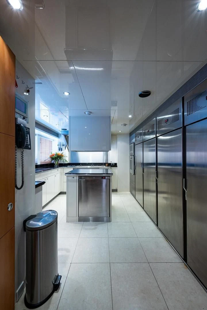 a kitchen with a glass door aboard SHARKFINN Yacht for Sale