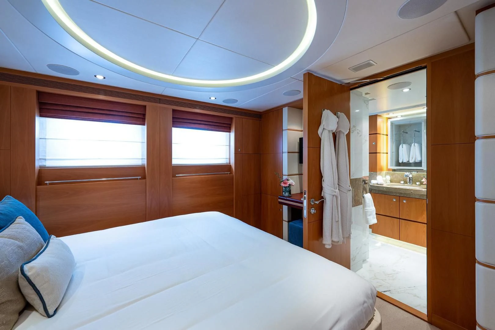 a bedroom with a bed and a closet aboard SHARKFINN Yacht for Sale