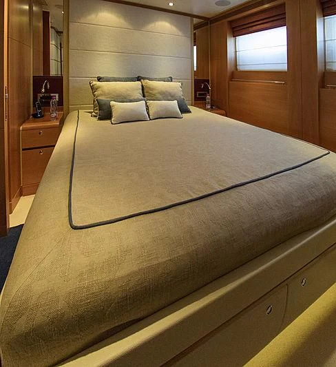 a bed with a blue sheet aboard SHARKFINN Yacht for Sale