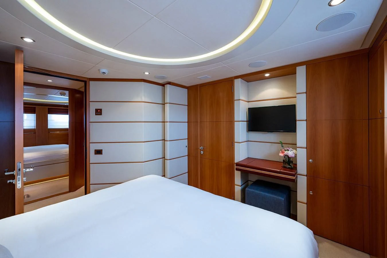 a room with a bed and a television aboard SHARKFINN Yacht for Sale