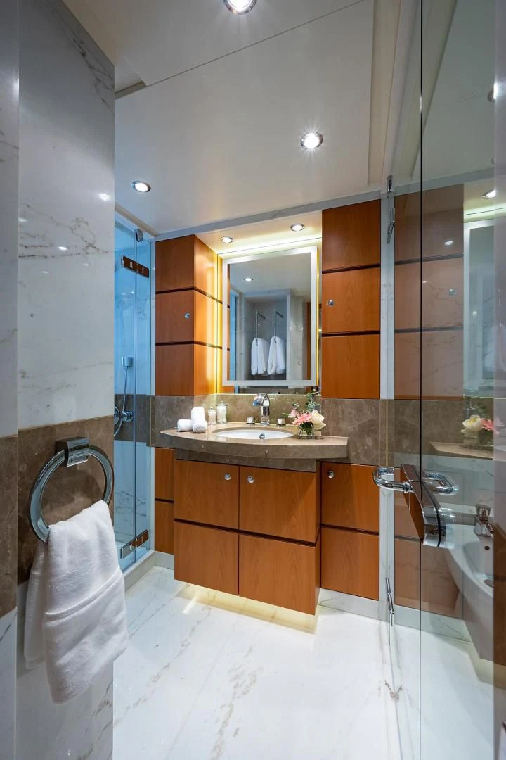a bathroom with a sink and a mirror aboard SHARKFINN Yacht for Sale
