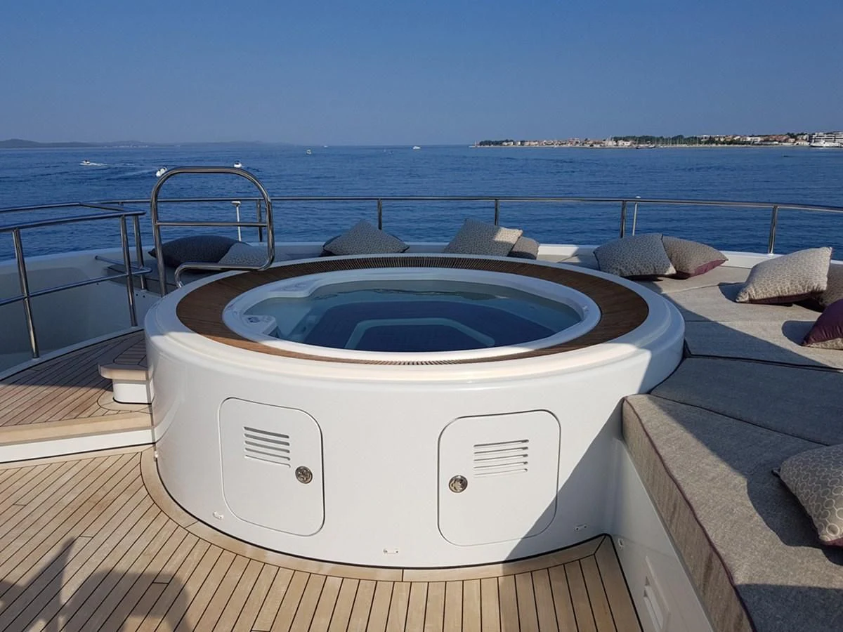 a large white tub on a deck overlooking a large body of water aboard SHARKFINN Yacht for Sale