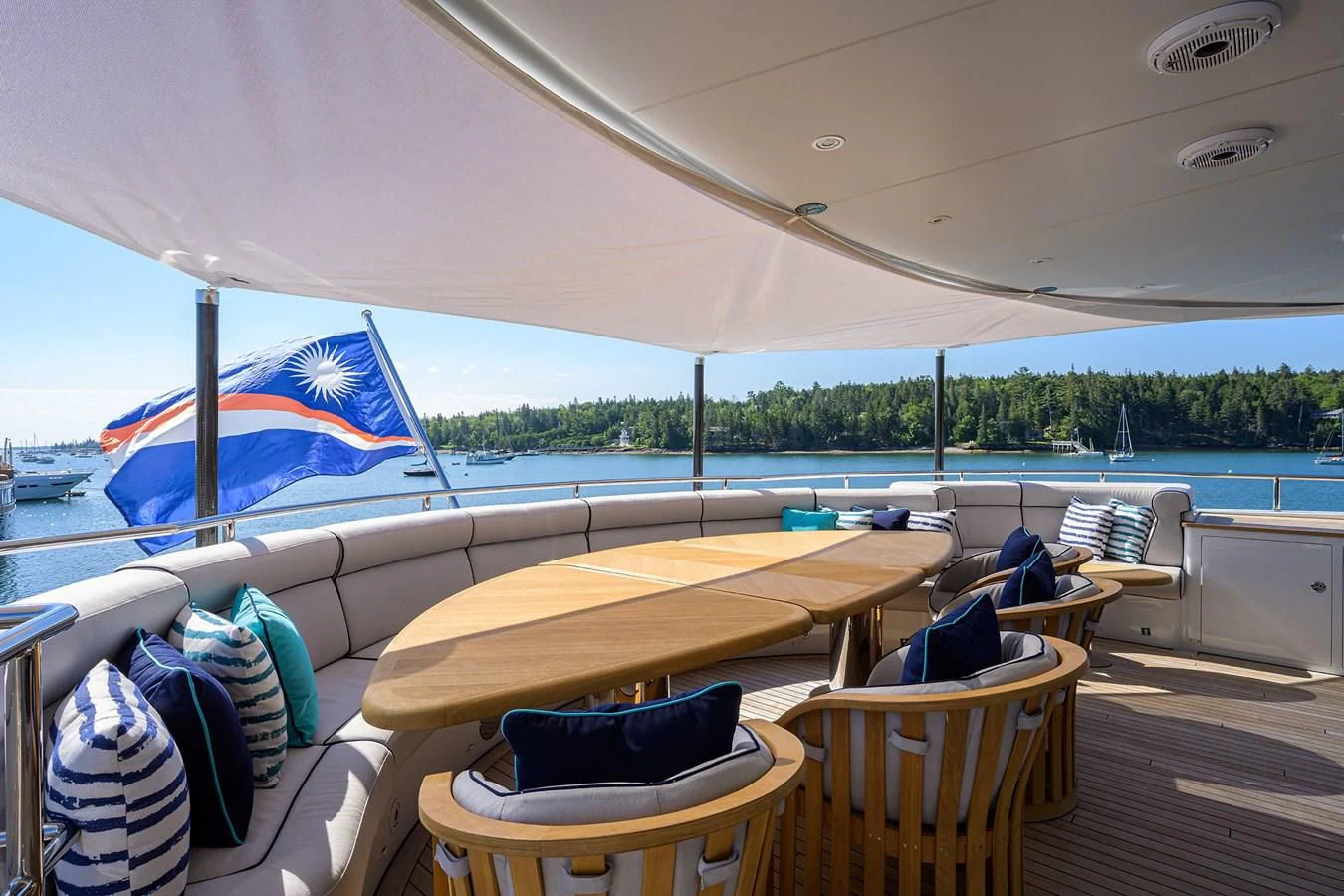 a boat with a table and chairs on the deck aboard SHARKFINN Yacht for Sale