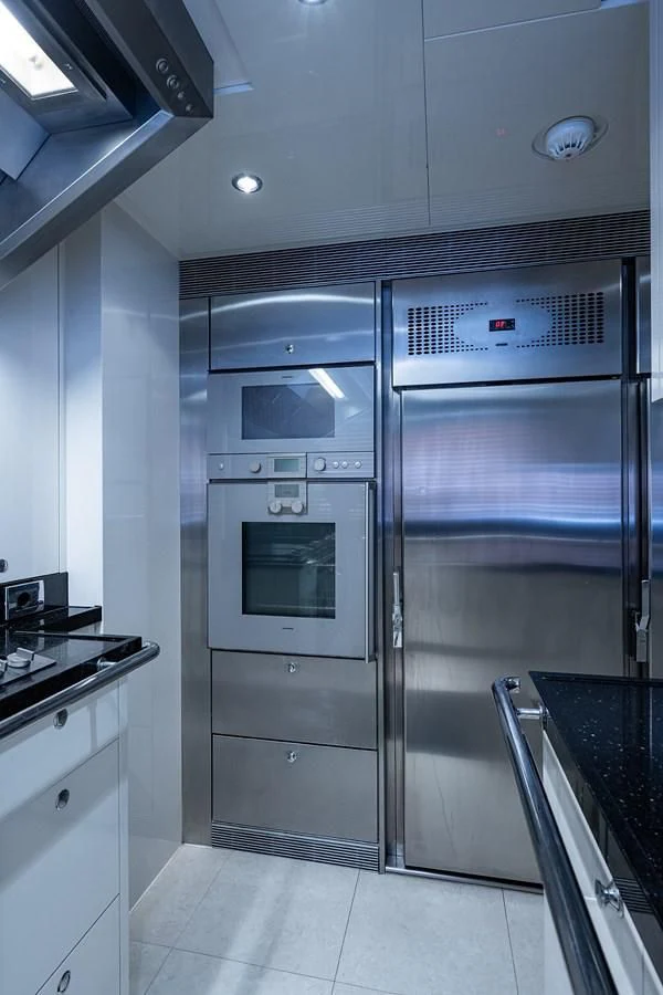 a large metal refrigerator in a kitchen aboard SHARKFINN Yacht for Sale