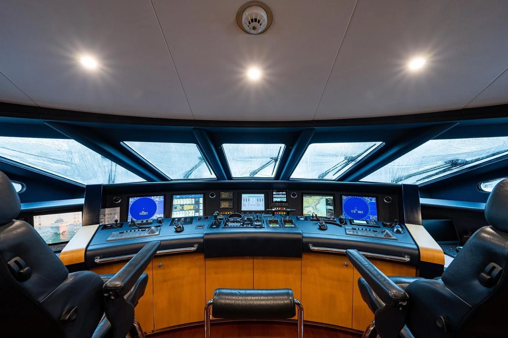 inside of a vehicle with seats and screens and a ceiling with lights aboard SHARKFINN Yacht for Sale