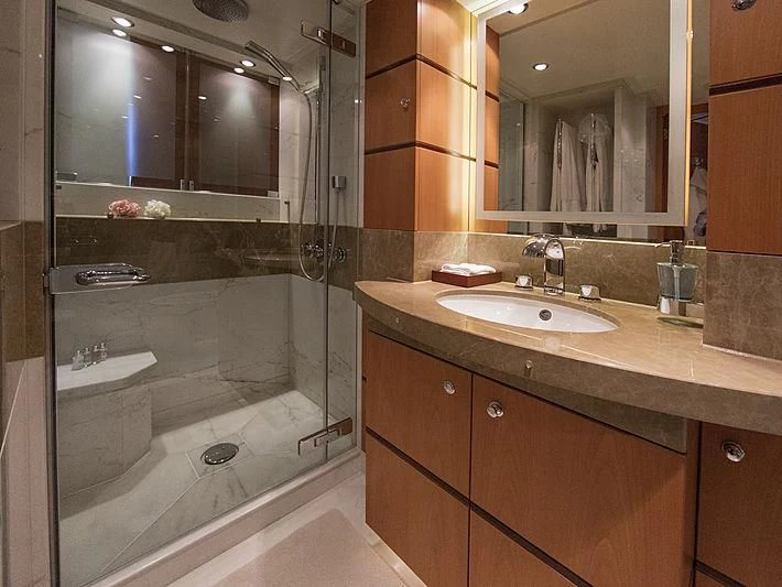 a bathroom with a glass shower aboard SHARKFINN Yacht for Sale