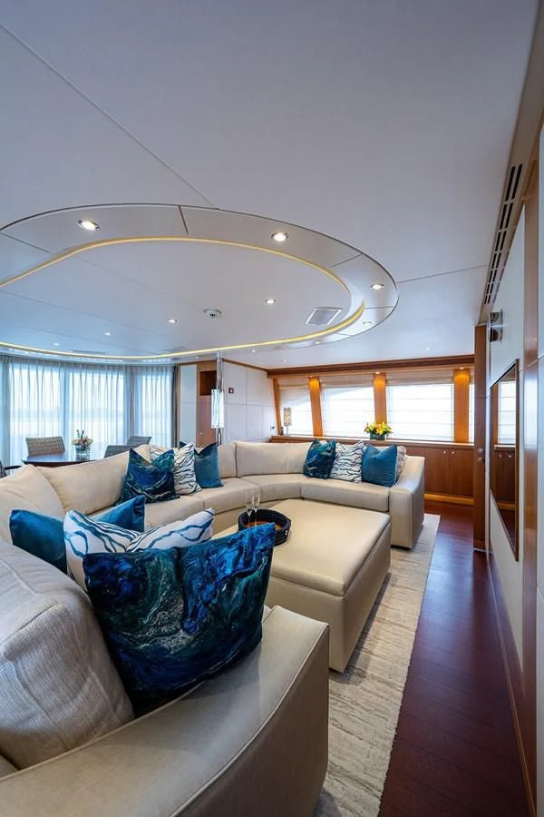 a living room with a large chandelier aboard SHARKFINN Yacht for Sale