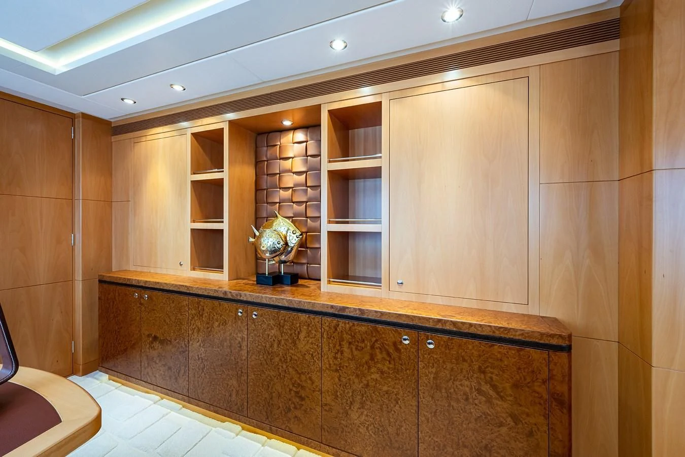 a wooden cabinet with glass doors aboard SHARKFINN Yacht for Sale
