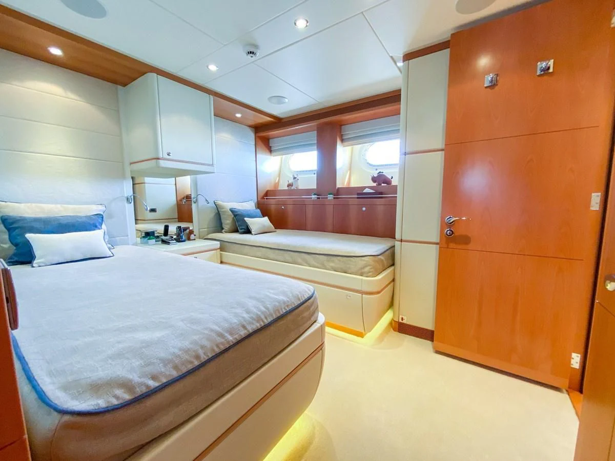 a room with a bed and a closet aboard SHARKFINN Yacht for Sale
