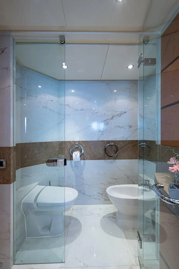 a bathroom with a glass shower aboard SHARKFINN Yacht for Sale