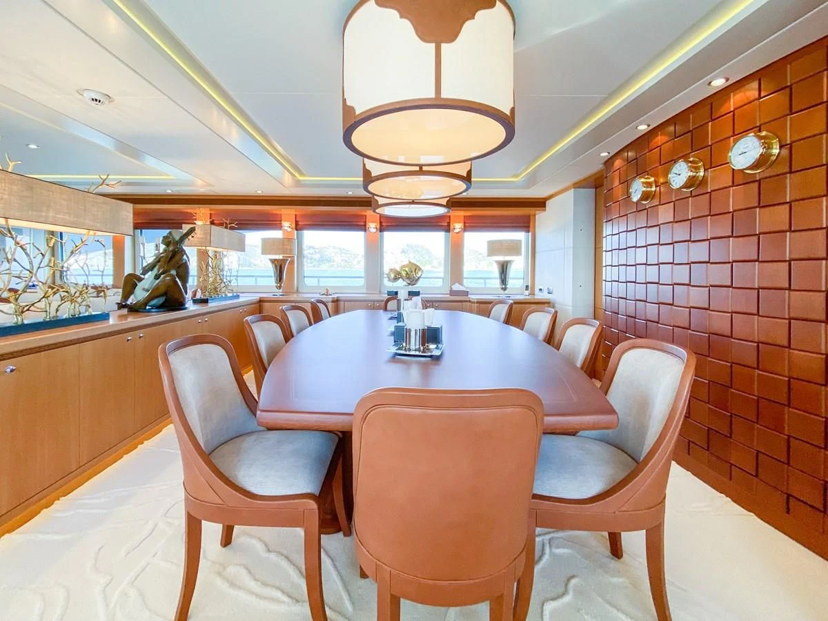 a dining room with a table and chairs aboard SHARKFINN Yacht for Sale