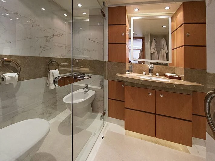a bathroom with a large mirror aboard SHARKFINN Yacht for Sale
