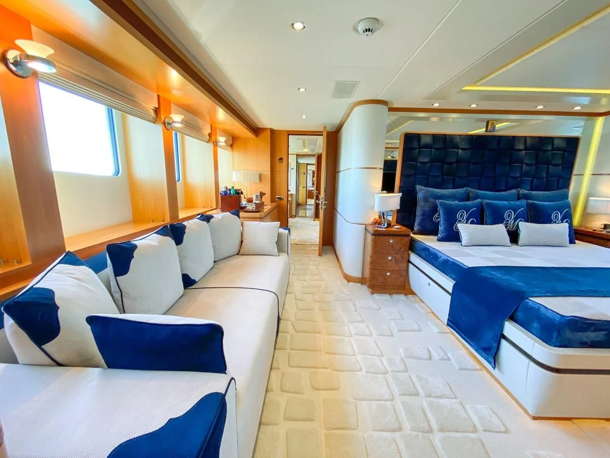 a room with a bed and a couch aboard SHARKFINN Yacht for Sale