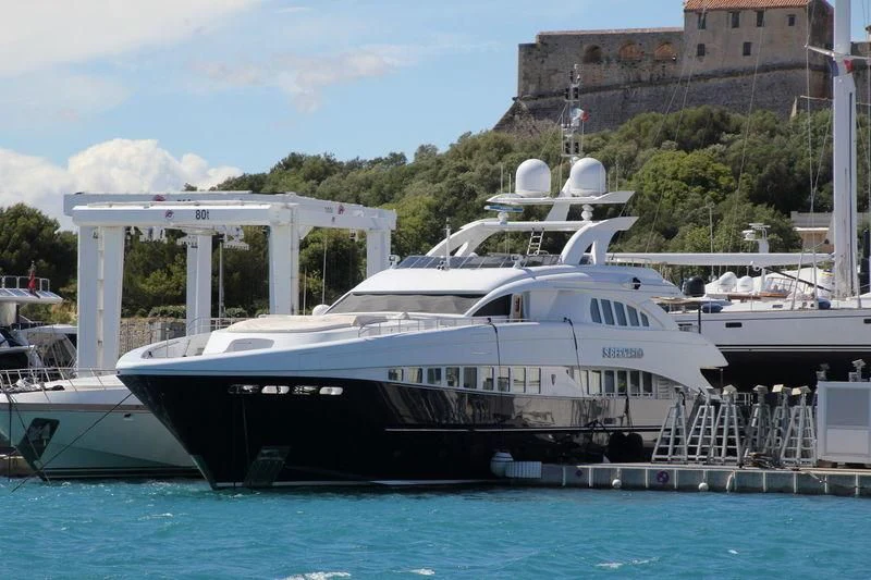 a large white boat sits in the water aboard SHARKFINN Yacht for Sale