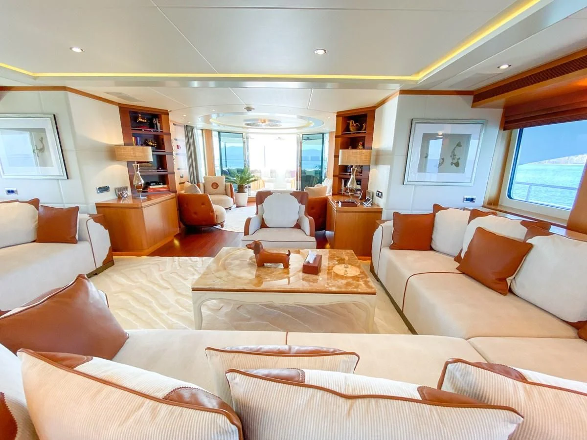 a living room with white couches aboard SHARKFINN Yacht for Sale