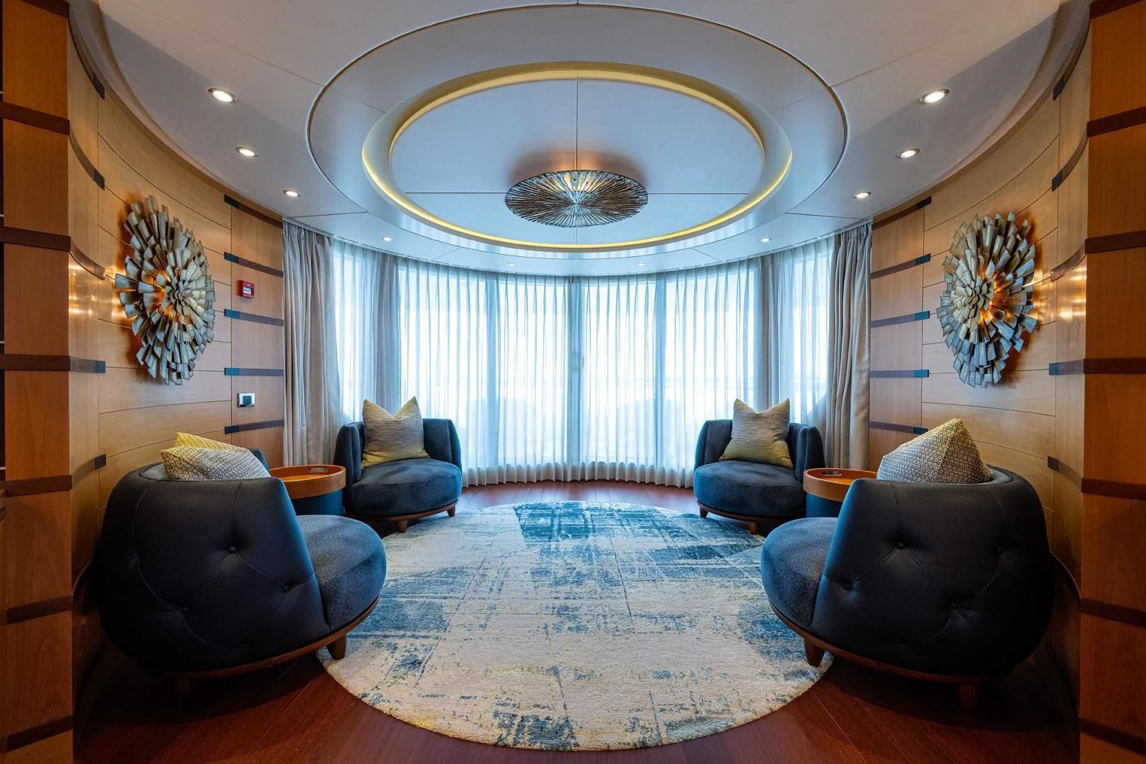 a large living room with a chandelier aboard SHARKFINN Yacht for Sale