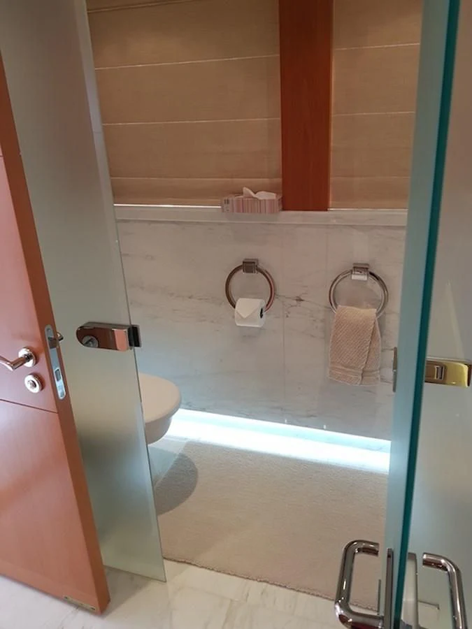 a bathroom with a shower and toilet aboard SHARKFINN Yacht for Sale