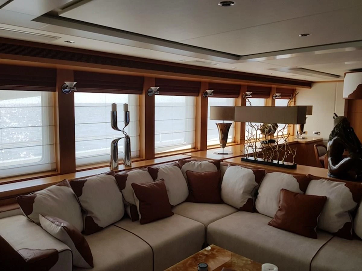a living room with a couch and a window aboard SHARKFINN Yacht for Sale