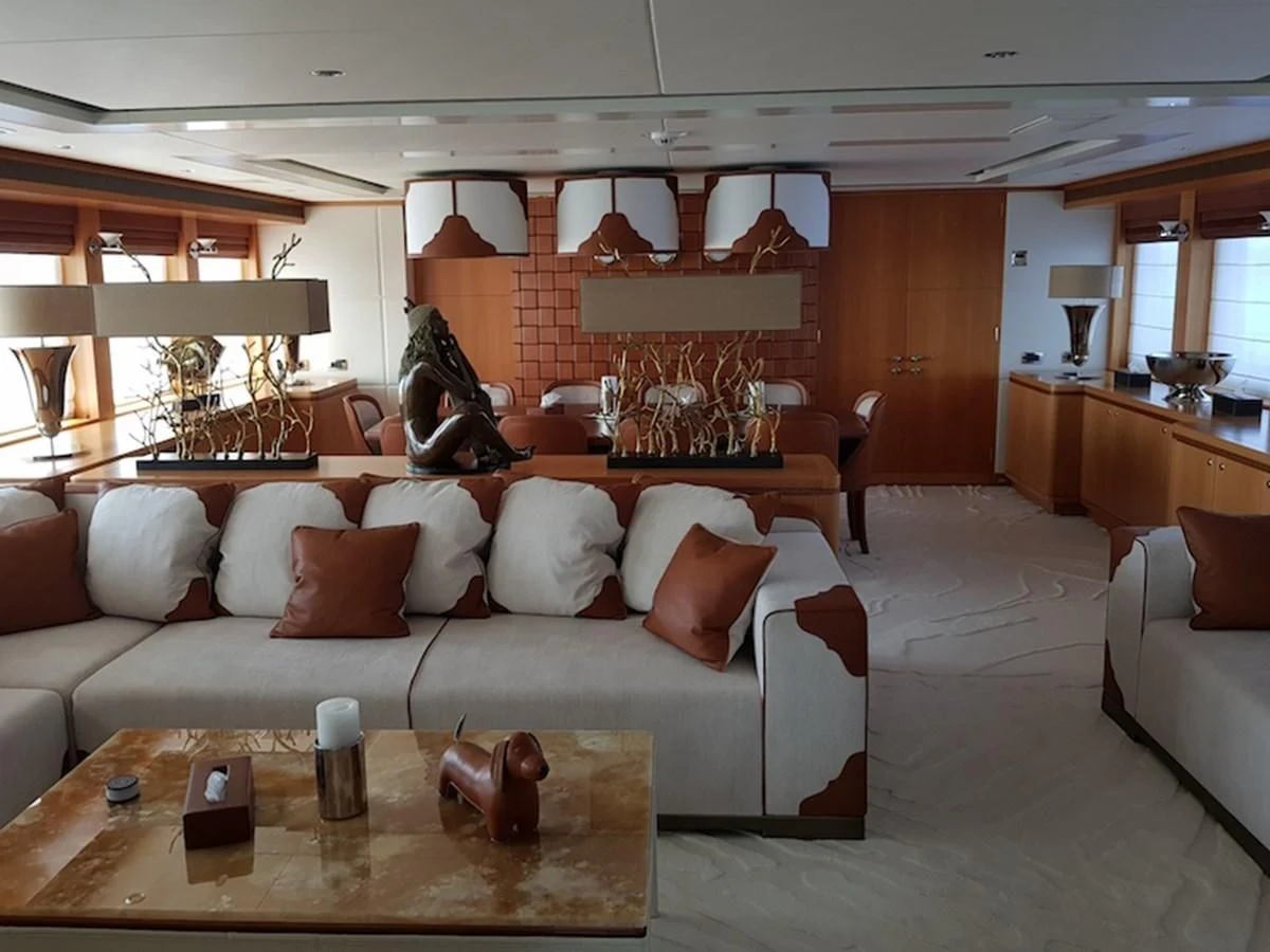 a living room with a couch and a table aboard SHARKFINN Yacht for Sale