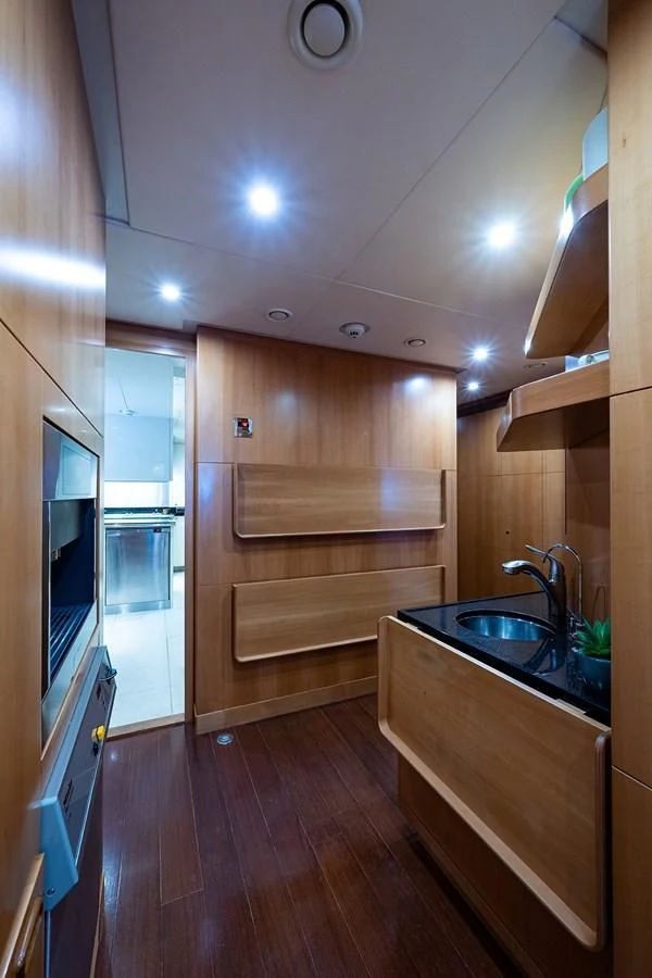 a kitchen with wooden cabinets aboard SHARKFINN Yacht for Sale