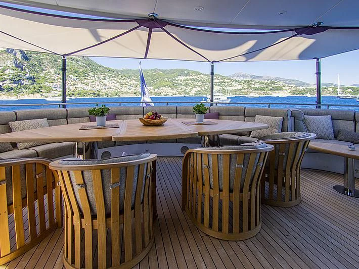 a table with chairs and a large window overlooking a large body of water aboard SHARKFINN Yacht for Sale