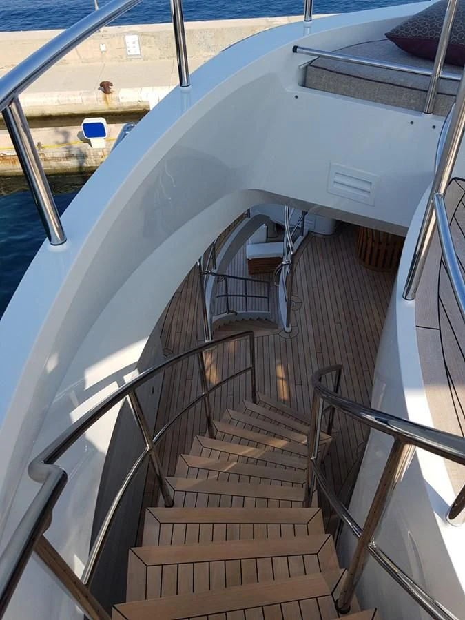 a large white boat with stairs aboard SHARKFINN Yacht for Sale
