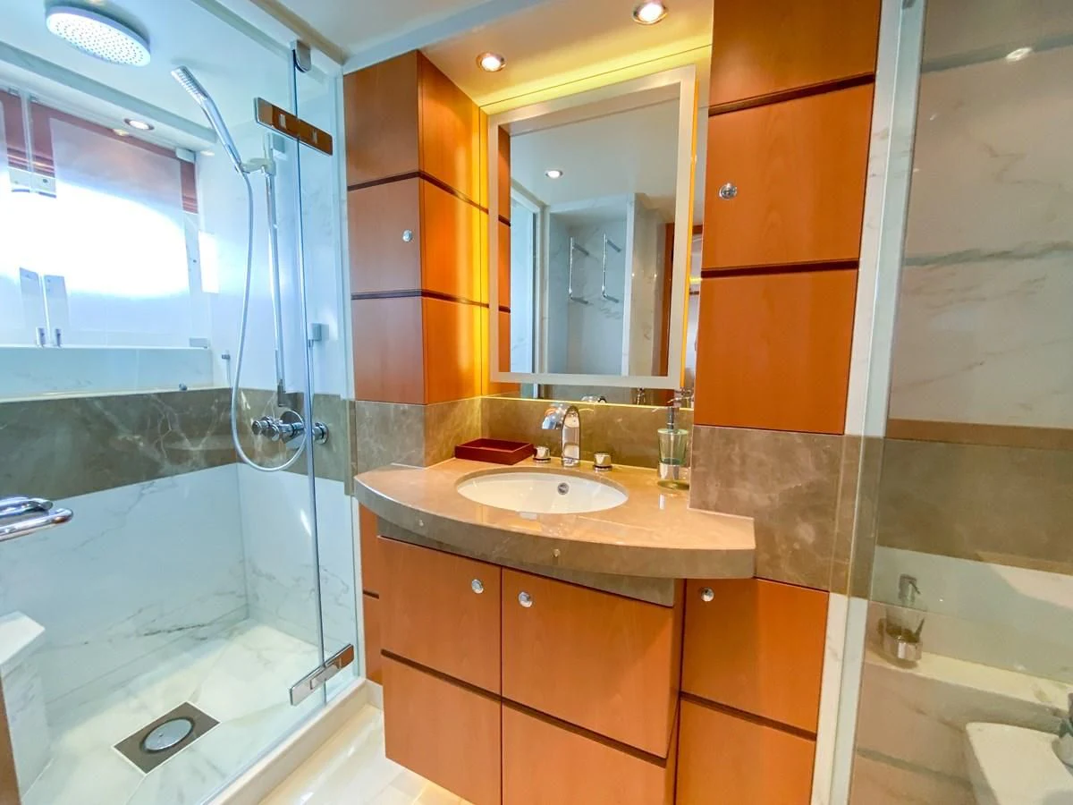 a bathroom with a glass shower aboard SHARKFINN Yacht for Sale