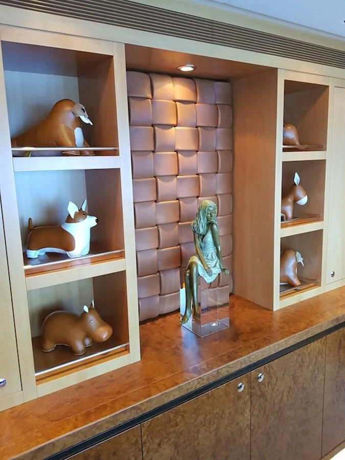 a shelf with a vase and a statue on it aboard SHARKFINN Yacht for Sale